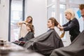 Beautiful woman combing wet hair. stylist brushing woman hair in salon. Hairdresser Serving Customer. Professional Young Royalty Free Stock Photo