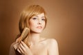 Beautiful Woman Combs Her Healthy Long Hair Royalty Free Stock Photo