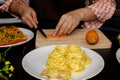 Beautiful woman cooking in new kitchen making healthy food with Royalty Free Stock Photo