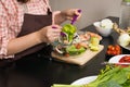 Beautiful woman cooking in new kitchen making healthy food with Royalty Free Stock Photo