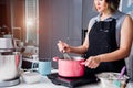 Beautiful woman cooking whisk dough in bowl manual