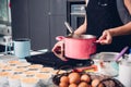 Beautiful woman cooking whisk dough in bowl manual