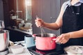 Beautiful woman cooking whisk dough in bowl manual