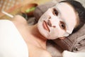 Beautiful woman with cotton mask sheet on face relaxing Royalty Free Stock Photo