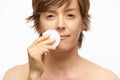 Beautiful woman with cotton pad, wiping off make up Royalty Free Stock Photo
