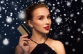 Beautiful woman with credit card over snow