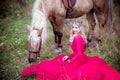 Beautiful woman in crown, blonde with horse. Princess in fairy tale.