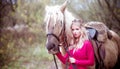 Beautiful woman in crown, blonde with light gray horse. Princess in fairy tale.