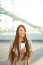 Beautiful Woman With Cup Of Coffee Walking On Street. Portrait Of Attractive Young Female In Stylish Office Clothes Holding Cup Of Royalty Free Stock Photo