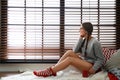 Beautiful woman with cup of hot drink near window at home. Lazy morning Royalty Free Stock Photo