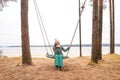 Beautiful woman with cup on Swing