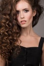 Beautiful woman with curly brown thick hair. Face closeup portrait Royalty Free Stock Photo