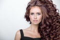 Beautiful woman with curly brown thick hair. Face closeup portrait Royalty Free Stock Photo