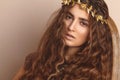Beautiful Woman. Curly Long Hair. Fashion Model. Healthy Wavy Hairstyle. Accessories. Autumn Wreath, Gold Floral Crown Royalty Free Stock Photo