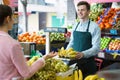 Beautiful woman customer buying yellow bananas Royalty Free Stock Photo