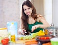 Beautiful woman cuts green celery Royalty Free Stock Photo