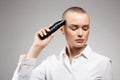 Beautiful woman cutting her hair. bald Girl with hairclipper Royalty Free Stock Photo