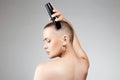 Beautiful woman cutting her hair. bald Girl with hairclipper Royalty Free Stock Photo