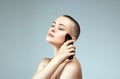 Beautiful woman cutting her hair.  bald Girl with hairclippe Royalty Free Stock Photo