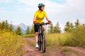 Beautiful woman cyclist rides a bicycle in nature. Healthy lifestyle and sports. Leisure and hobbies