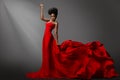 Beautiful Woman dancing in Red waving Dress on Stage. Fashion Dark Skin Model in long Gown Side View. Stylish Girl with Afro hair Royalty Free Stock Photo