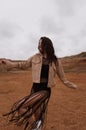 beautiful woman with dark hair in casual clothes posing in desert of Cyprus