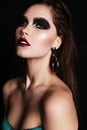 Beautiful woman with dark hair and extravagant black smokey eyes makeup Royalty Free Stock Photo