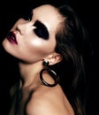Beautiful woman with dark hair and extravagant black smokey eyes makeup Royalty Free Stock Photo