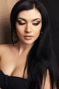 Beautiful woman with dark hair with golden make up