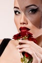 Beautiful woman with dark red roses flower in veil retro glamour Royalty Free Stock Photo