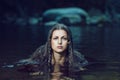 Beautiful woman in dark water stream