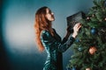 Beautiful woman decorating Christmas tree