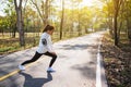 A beautiful woman do stretching legs before running in city park Royalty Free Stock Photo