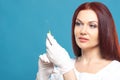 Beautiful woman doctor cosmetologist holding syringe with solution for beauty injections. isolated female studio portrait Royalty Free Stock Photo