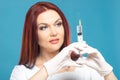Beautiful woman doctor cosmetologist holding syringe with solution for beauty injections. isolated female studio portrait Royalty Free Stock Photo