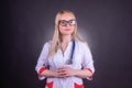 A beautiful woman doctor in a medical gown with glasses and a stethoscope around her neck Royalty Free Stock Photo