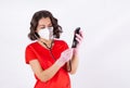 A beautiful woman doctor in a medical mask checks her smartphone with a stethoscope Royalty Free Stock Photo