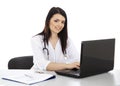 Beautiful woman doctor working on a laptop and smiling Royalty Free Stock Photo