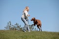 Beautiful woman with dog rhodesian ridgeback hound outdoors on a field Royalty Free Stock Photo