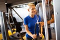 Beautiful woman doing exercises in gym with personal trainer Royalty Free Stock Photo