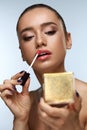 Beautiful Woman Doing Makeup Putting Lipgloss On Lips. Cosmetics Royalty Free Stock Photo