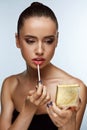 Beautiful Woman Doing Makeup Putting Lipgloss On Lips. Cosmetics Royalty Free Stock Photo