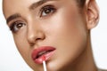 Beautiful Woman Doing Makeup Using Lip Gloss On Lips. Cosmetics Royalty Free Stock Photo