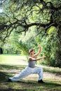 Beautiful woman doing Tai Chi in park. Royalty Free Stock Photo