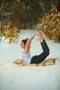Beautiful woman doing yoga outdoors in snow Royalty Free Stock Photo