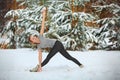 Beautiful woman doing yoga outdoors in snow Royalty Free Stock Photo