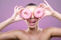 Beautiful woman with donuts, his two eyes are pink donut