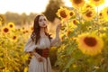 Beautiful woman in a dress in a field of sunflowers Royalty Free Stock Photo