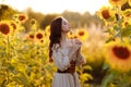 Beautiful woman in a dress in a field of sunflowers Royalty Free Stock Photo