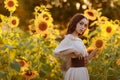 Beautiful woman in a dress in a field of sunflowers Royalty Free Stock Photo